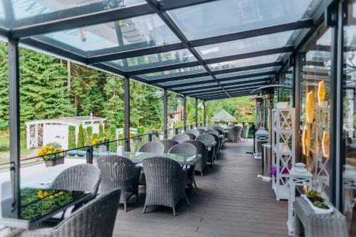 a row of tables and chairs on a patio at Hotel Vedmezhyi Dvir in Bukovel