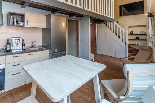 a kitchen with a white table and a staircase at Solmi Home in Modena
