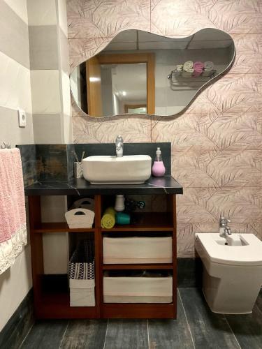 a bathroom with a sink and a mirror at Eva Santa pola in Santa Pola