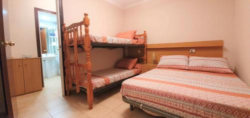 a bedroom with two bunk beds and a bed at Miramar Serveis - Pins II in Cambrils