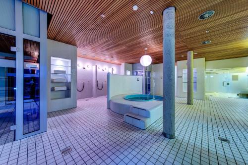 a bathroom with a shower in the middle of a room at Collegium Glashütten in Glashütten