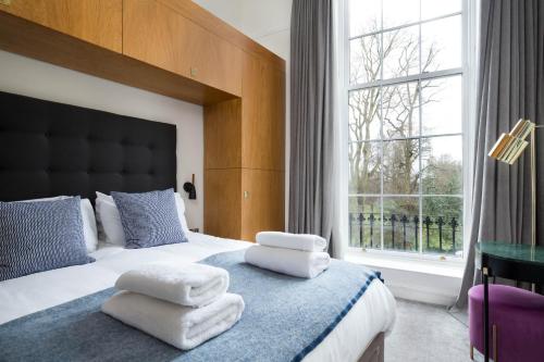 a bedroom with a bed with white towels on it at Magnificent Georgian 3-Bedroom Apartment in New Town in Edinburgh
