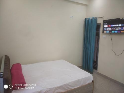 a hospital room with a bed and a tv at Braj Waterpark & Resort in Kannauj