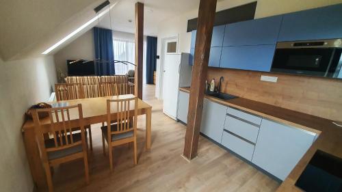 a kitchen and dining room with a table and chairs at Apartmány Semily in Semily
