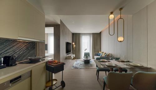 a kitchen and a living room with a dining room at Pan Pacific Serviced Suites Kuala Lumpur in Kuala Lumpur