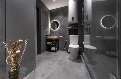a bathroom with a toilet and a sink at Shades of gray - NEW DELUX Apartments in Kyiv