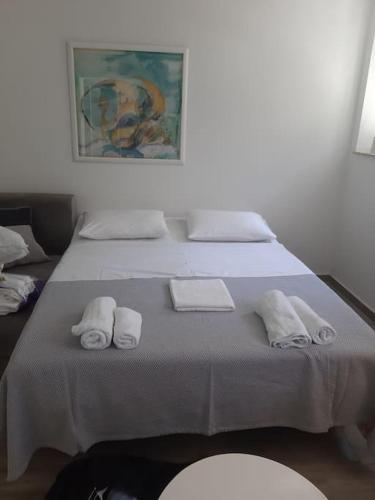 a large bed with towels on top of it at Apartman Modric Draga in Mošćenička Draga
