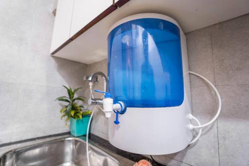 a kitchen sink with a blue water dispenser at Homlee-Basement Flat with kitchen in Saket, South Delhi in New Delhi