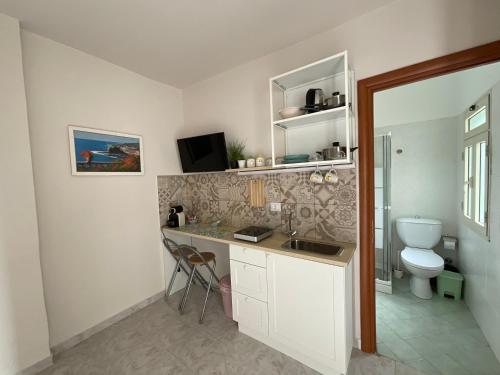 a bathroom with a sink and a toilet in it at Nova Home in Catania