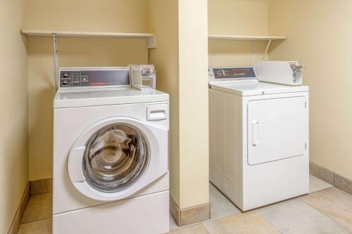 a washing machine and a dryer in a room at AmericInn by Wyndham Madison South in Madison