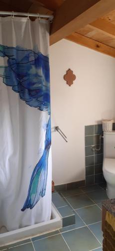 a bathroom with a shower curtain with a peacock on it at Maison de Campagne l'étang in Seillans