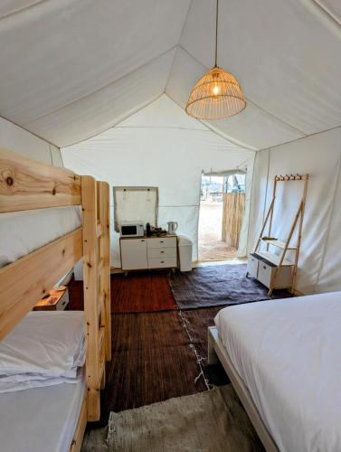 a bedroom with two bunk beds and a mirror at Park Timna in Eilat