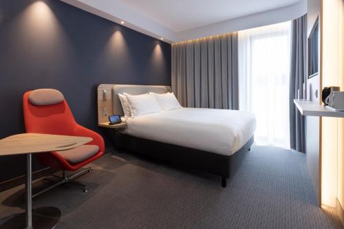 a hotel room with a bed and a desk and a chair at Holiday Inn Express & Suites - Deventer by IHG in Deventer