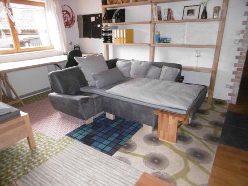 a living room with a couch and a table at Mühlenwörth Relax Quartier in Tauberbischofsheim