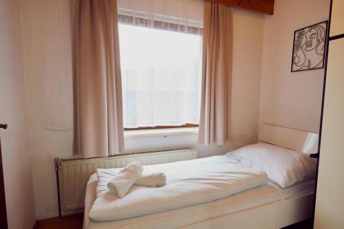 a bed in a room with a window at The Art and Sporthotel in Innsbruck