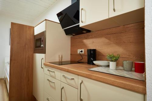 a kitchen with white cabinets and a counter top at The Art and Sporthotel in Innsbruck