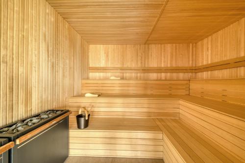 a sauna with wooden paneling and a wooden floor at Hotel de Schelde in Cadzand-Bad