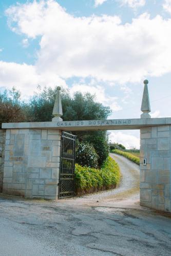 a gate in a stone building with a road at Just Like Home - Casa do Rosmaninho in Caminha