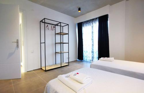 a bedroom with two beds and a towel rack at Astonis in Belek