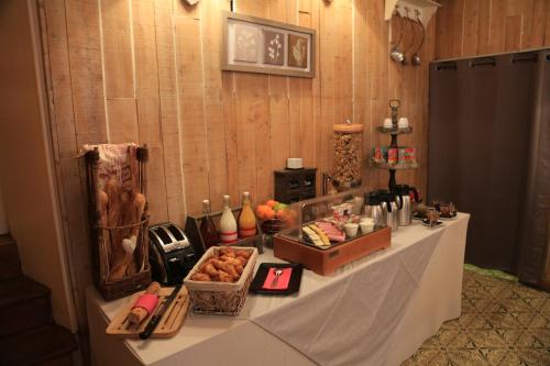 a table with food on it in a room at Auberge de la Paix in Briançon