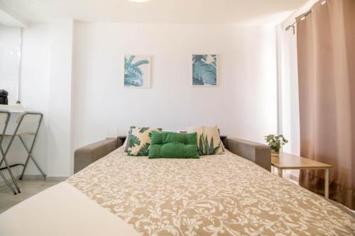 a bedroom with a large bed with green pillows at Erisa 55 by IVI Real Estate in Torremolinos