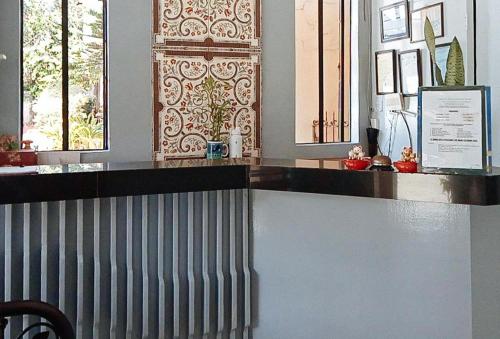 a counter in a room with two windows at Casa Don Atilano Pension House in Zamboanga