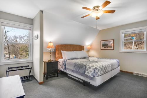 a bedroom with a bed and a ceiling fan at Homestead On The Hillside in Baraboo