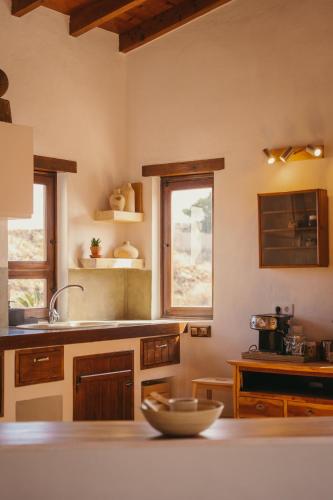 a kitchen with a counter with a bowl on a table at Casa Maja in Lajares