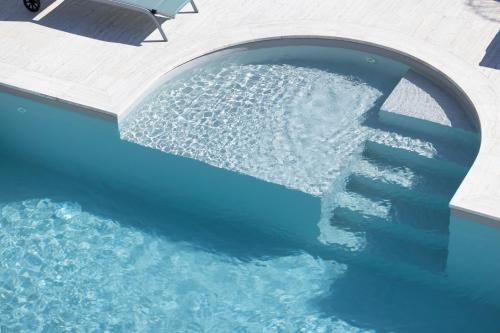 a pool of water with a stair in the middle at Dimora Lauro in Gagliano del Capo