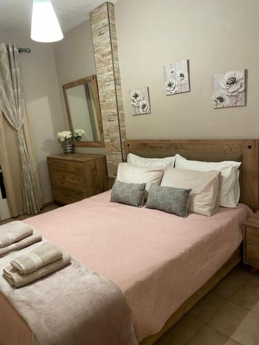 a bedroom with a large bed with two towels on it at The Odyssey Holiday Home - Agios Ioannis, Pelion in Agios Ioannis Pelio