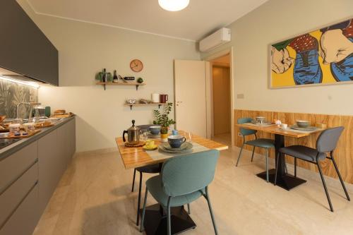 a kitchen and dining room with a table and chairs at Dimora Lauro in Gagliano del Capo