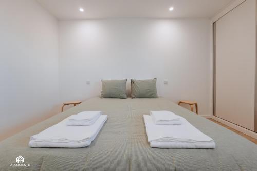 a large bed with two white pillows on it at The Terrace - Santa Cruz in Santa Cruz