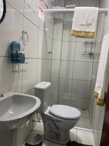 a small bathroom with a toilet and a sink at Flat JK 102 in Juazeiro do Norte