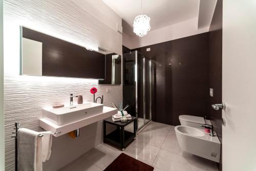 a bathroom with a sink and a toilet at MINERVA LUXURY TOWN CENTER , POOL AND PARKING in Taormina