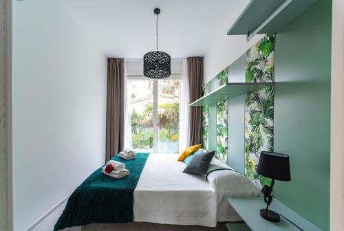 a bedroom with a bed and a window at MINERVA LUXURY TOWN CENTER , POOL AND PARKING in Taormina