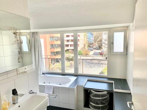 a bathroom with a sink and a large window at Hawa Apartment - two balcony - by PA in Luzern