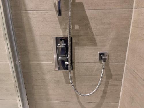 a shower in a bathroom with a glass door at Lovely 2 Double Bedroom Flat with free parking - At the Atrium MK in Milton Keynes