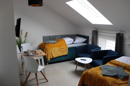 a bedroom with a bed and a couch and a table at Apartments Morsum in Thedinghausen