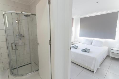 a white bedroom with a shower and a bed at Villa Reyets 4 bed 3 bath Private Pool in Busot