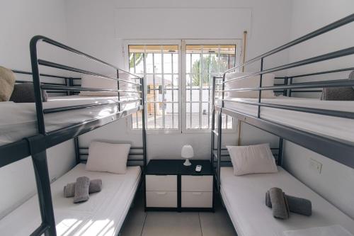 two bunk beds in a room with a window at Villa Reyets 4 bed 3 bath Private Pool in Busot