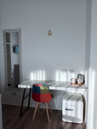 a dining room table with a chair and a mirror at B&B LA VALLUNA in Erbusco