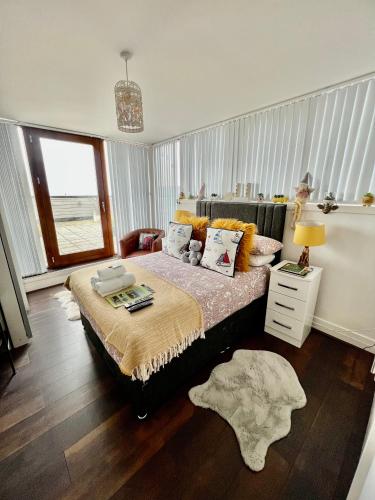 a bedroom with a large bed and a window at James Clow Bed & Breakfast in Belfast