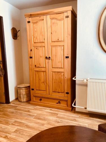 a wooden cabinet in the corner of a room at Penzion, Restaurace Jaro Věšín Brdy in Věšín