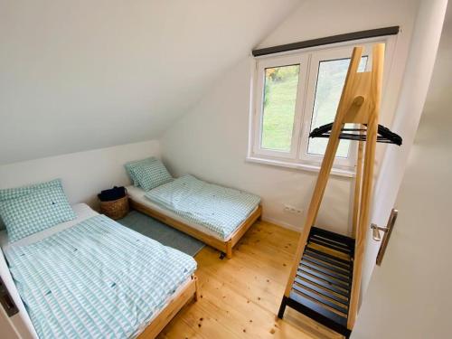a room with two beds and a window at Chata Cérov in Púchov
