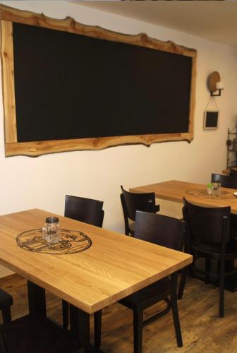 a classroom with wooden tables and chairs and a blackboard at Penzion Puk in Hrob