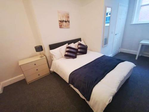 a bedroom with a bed with two pillows on it at Wardwick Guest House in Derby