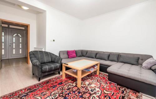 a living room with a couch and a table and a chair at Apartments Dedić in Supetarska Draga