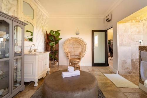 a bathroom with a round table and a sink at Alphen Drive Apartments in Cape Town