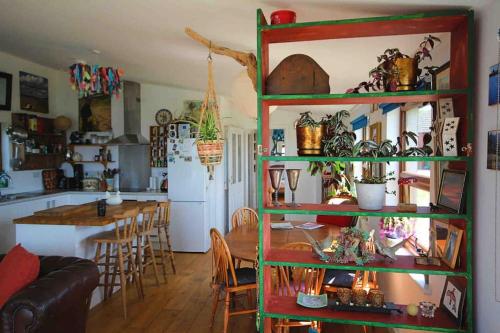 布德的住宿－Spacious cabin on isolated farm with sea view，一间厨房和带绿色架子的用餐室