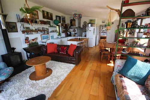 a living room with a couch and a table at Spacious cabin on isolated farm with sea view in Bude